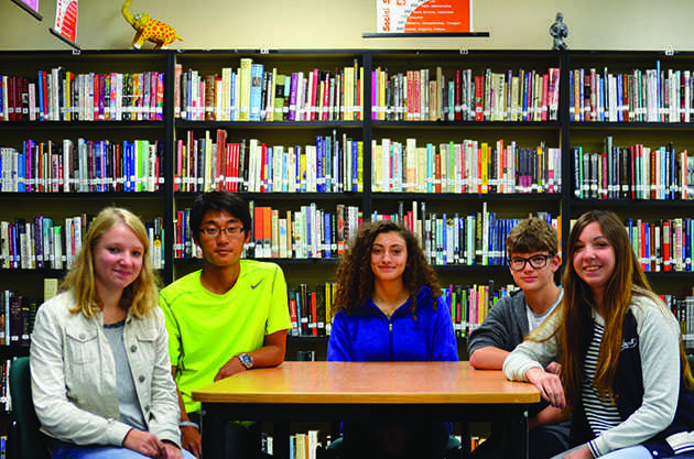 United nations: Noemie Bonbled, Wataru Morishita, Maria Valentini, Jonas Pletscher, Agustina Coll gather together at a table in the library. Being able to speak English well was a motivator for this year’s exchange students to come to the United States. “I wanted to speak English [ever] since I was very little,” sophomore Noemie Bonbeld from Belgium said. 