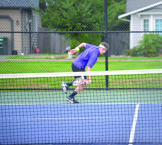 Aced it: Senior Griffin Lee rearing up for a strong back hand stroke. During the match on October 14 against Snohomish, they lost but still came out on top with with positive attitudes. "I aced the number one single in the league," Lee said.