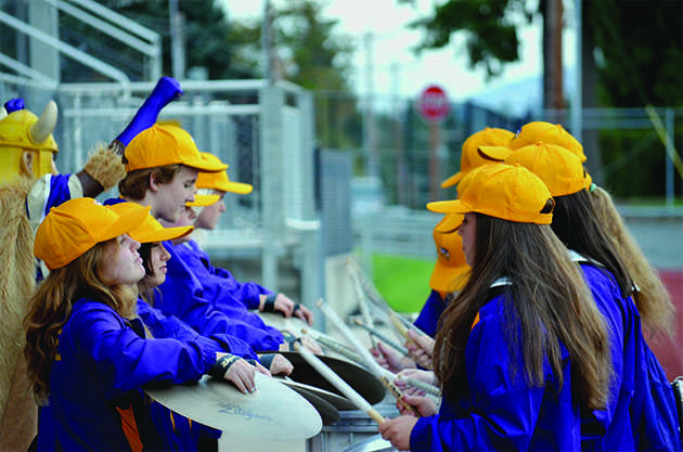 The 2015-2016 LSHS Drumline (left to right: Jeyda Tomson, Martha Boe, Jocelyn Van Der Put, Emily Anne Bray, Ashley Mahan, Hailey Holder, Cassandra Jennings and other drumline members play for the superfans while the Viking dances along. Before the first football game the drumline played “Senate” in order to get the ball rolling. “We always look forward to getting everybody excited and pumped up for the football team and band,” Co-drumline captain class? Leinani Tadio said . 
