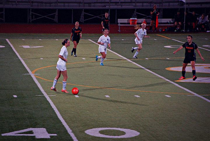 Senior Madison Huesers controls the ball against Monroe and helps bring the Girls' Soccer team to a 1-0 victory. Despite a rough start, the team managed to bring it together in the second half when Huesers scored the winning goal  “We finally got to a place where we worked hard together and for each other till the end of the game. At halftime we talked through the first half and decided what we needed to change in the second half to win. In the end we didn't play selfishly but for our teammates,” senior Ashley Perry said. 