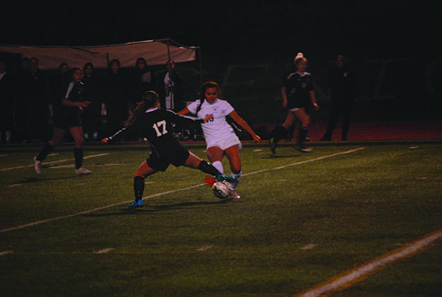 Senior Jenna Sampson tries to keep ball in the  Viking's possession at the game against Kamiak on November 3. Though they fought hard to win this game the team lost to Kamiak 0-2. However they defeated Monroe and are ready to take on Kamiak again to continue in the competition. "We played well but it didn't turn out as well as me hoped," Sampson said referring to the November 3 game.