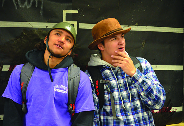Say scream: Seniors Trysten Perales and Austin Strawder pose for this year's DECA photobooth with prop hats. Both boys selected from an array of mask and Halloween themed props for their picture in the blood spattered booth that were delivered to them this past Friday. “It was a very good set-up, very well done. I liked all the props,” Strawder said “It’s very good, [the photobooth] unites people.”