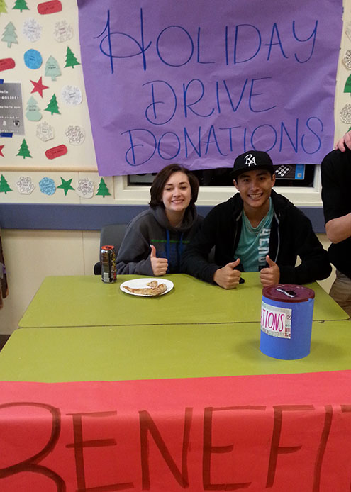 Junior Bryn Kane and junior Connor Olmstead collect money donations from students during lunch to benefit the Lake Stevens Food Bank.