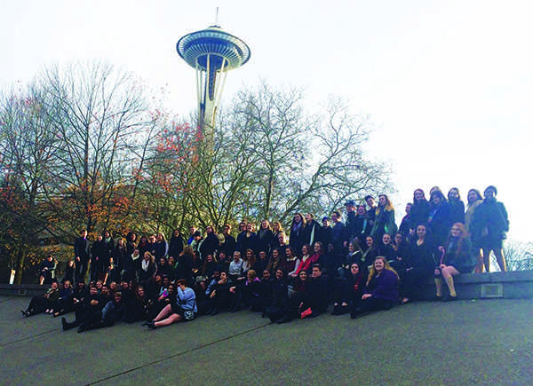 All three choirs pose for a photo at Seattle Center in front of the Space Needle. The groups performed at the Wintertide festival with song selections from Pentatonix, Idina Menzel, Kristen Bell, and The Sound of Music. 
