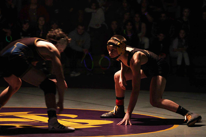 Senior Gino Loera stands ready against his opponent. As a team the wrestlers have struggled in dual meets, but are focused to be prepared for State. “The coaches and everything will really build you up as a wrestler...But the coaches can't do it all. It really takes all the kids on the team to go out of their way and bring new kids in and actually support each other,” senior Jake Douglas said.