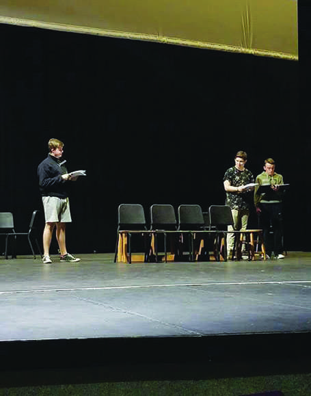 Senior Josh Allinson, junior Jakob Cody, and senior Nathaniel Gaswint learn the blocking on the stage during the rehearsal. 