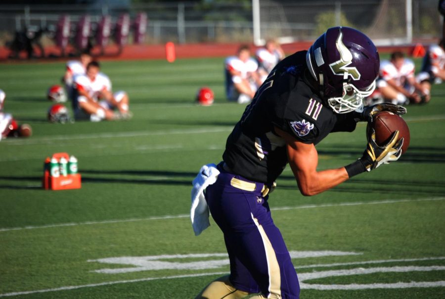 Senior wide receiver Tyler Owen catches a pass during pregame warmups before their matchup against Stanwood on September 1. Lake Stevens beat the Spartans 49-0. Owen is one of many targets senior quarterback Conor Bardue can throw to throughout the season.