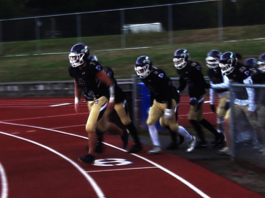  A group of Vikings, led by Austin Calvin (7) and Riley Eberlein (6), go onto the field prior to their matchup against Jackson. The Vikings won 49-7. They were led by senior Ryan Sander, who had two interceptions, one for a touchdown.