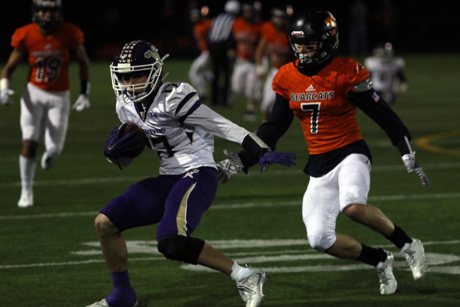 Senior Anthony Hutchinson evades Monroe sophomore Efton Chism III during the first quarter of friday’s game at Monroe High School. The Vikings won 38-12. With the win, the Vikings won their fifth straight Wesco championship and will play Kentlake at home next week.