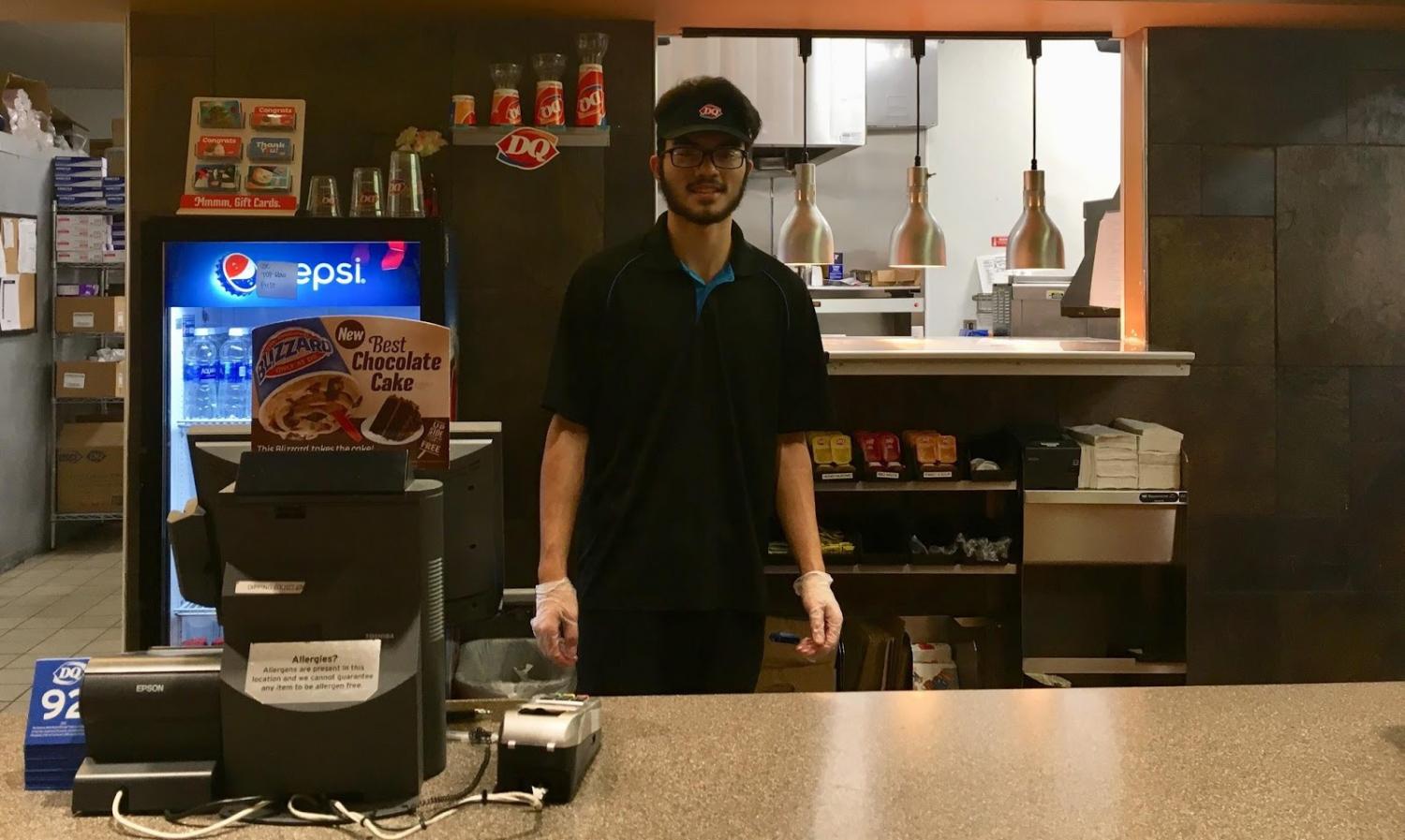 Serving Food with a Smile: Aaron Moors awaits customers at the Lake Stevens Dairy
Queen. Moors worked at the front counter happily serving others. “At my job I clean
machines and grills, prepare food and drinks, clean floors and do dishes at the end of the night,” Moors said.