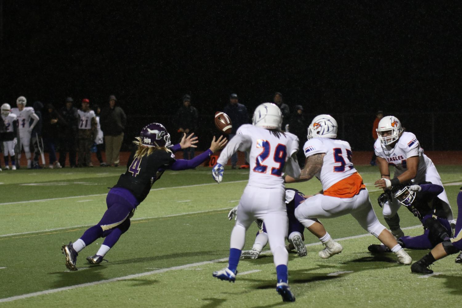 Junior Tre Long attempts to recover a fumble right in front of a mass of Graham Kapowsin defenders. The Vikings lost 38-31. Tre Long threw a career high 464 yards against the tough Eagle defense.