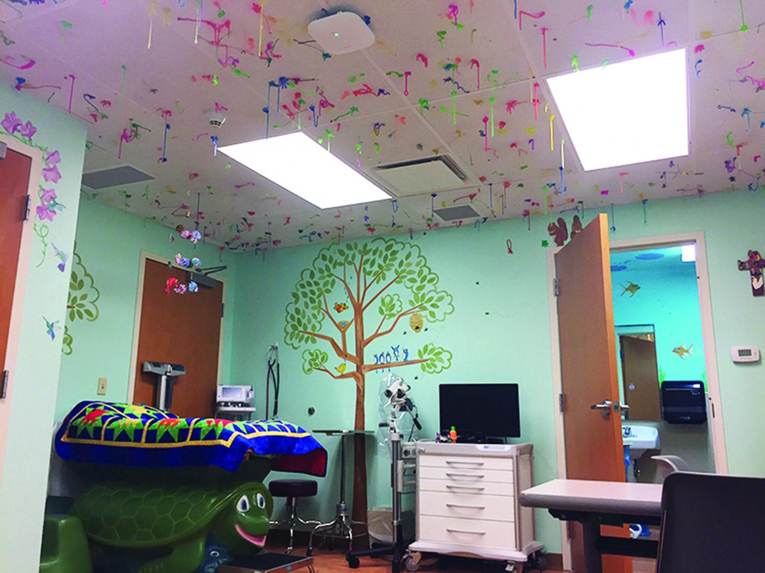 Majority minors: During tour, Executive Director Lori Vanderburg shows an exam room within Dawson Place. Though they offer services to any age of individual, the staff the staff Dawson Place see a majority of kids aged 7-12. After their exams, patients are invited to throw a sticky hand onto the ceiling of the exam room, creating an impactful visual showing them they are not alone. “90-95% of sexual violence happens with someone you know. Somebody at your Thanksgiving table, somebody at your Hanukkah celebration, whatever it is,” Vanderburg said in reference to their largest largest demographic.