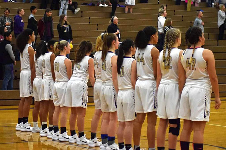 It%E2%80%99s+time+to+play+ball%21+The+Girls+Basketball+team+lines+up+as+they+get+ready+to+play+Kamiak.+Before+standing+for+the+pledge+the+team+warmed+up+shooting+free+throws%2C+three%E2%80%99s+and+working+on+layouts.+%E2%80%9CI+wish+more+people+would+come+out+and+support+our+team%2C+the+season+so+far+as+been+really+successful+and+I+hope+to+see+more+people+at+our+games%2C%E2%80%9D+senior+Laycie+Taylor+said.+