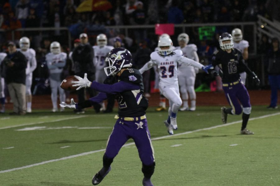 Playing for the Moment: Senior running back Kayshawn Mounarath catches a pass against the Graham-Kapowsin Eagles. The Vikings lost the game 38-31, taking away any chance for the seniors to take home a state title. "There were some disappointment from some of the football players, especially the seniors," senior Jevon Morris said.  
