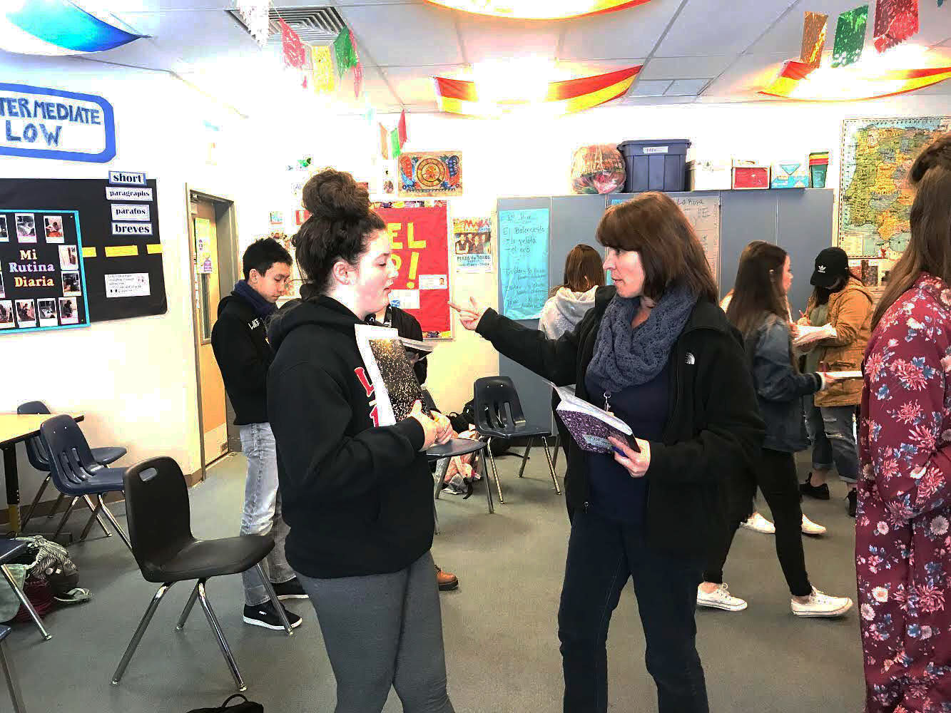 Social and Welcoming. Sra. Arcos and class Tiffany McAllister converse back and forth to help during an in-class activity. Throughout the class, students walked around and spoke with each other by asking questions and then filling out a chart they were assigned. “Today we were learning how to have full-on conversations in Spanish, rather than just asking “how are you” and being done with it.” sophomore Dan Nguyen said.