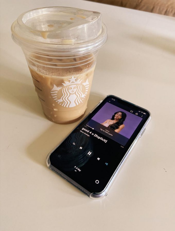 Singing Siren: Starbucks drink and a phone displays Olivia Rodrigo's third viral song,