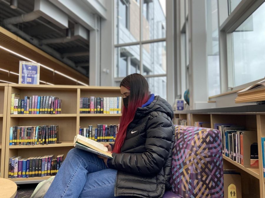 Relax and catch a good book! Junior Ximena Solis reads Linger by Maggie Stiefvater in the library during lunch.  "You can escape into a different world,"  junior Emma Saylor said.