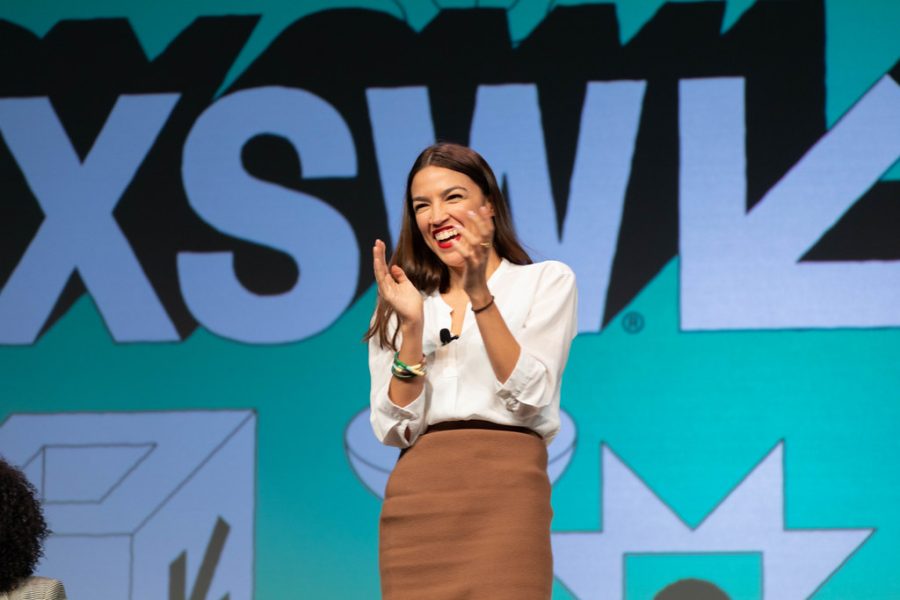 Alexandria Ocasio Cortez takes the stage at a conference in 2019.