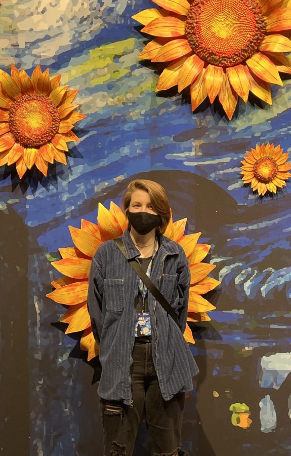 Blossoming+Growth%3A+Junior+Gabrielle+Dacar+stands+in+front+of+sunflowers+at+the+exhibition+entrance.+The+Van+Gogh+Experience+is+a+360%C2%B0+immersive+exhibition+of+the+artist%E2%80%99s+work+and+lifetime+to+show+it+to+a+new+audience+in+a+new+light.+%E2%80%9CBringing+to+life+the+culture+and+how+people+visualize+things%2C+it%E2%80%99s+very+important.+It+brings+in+individualism+and+just+a+new+way+of+viewing+aspects+of+life%2C%E2%80%9D+senior+Lillianne+Head+said.