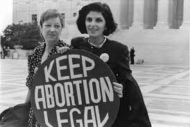 Photo of Norma McCorvey, featured on the left, and her attorney, Gloria Allred, featured on the right, outside the US Supreme Court in 1989.