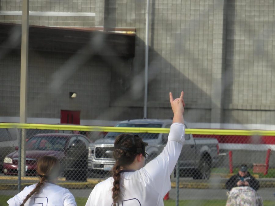 Strike! youre out!: Senior Kyleigh Lynn holds up horns towards the outfield after pitching a strike. Lake Stevens fans bundled up in the stands at MPHS, as words of encouragement were said from teammates in the dugout. Im excited for this season and how far well go, sophomore Ava Heston said.