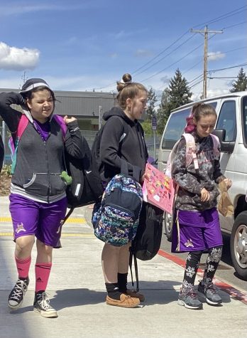 Game ready: Grace, Riley and Alexandra walk to their van to travel to their soccer game. The Unified Soccer Team has been training for these games and working together as a team.  I like listening to music and singing, said Riley Smith.