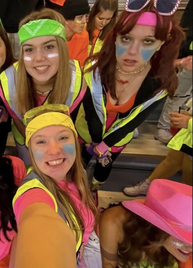 Bring on the night and neon lights! Seniors Sydney Adee, Abby Ray, and Hannah Hackney show off their neon attire in the student section. On Oct. 28, the dress-up theme for the last home football game was neon and boy did fans go crazy! "My favorite theme is neon just because of some of the outfits people put together," junior Trevor Adkinson said.