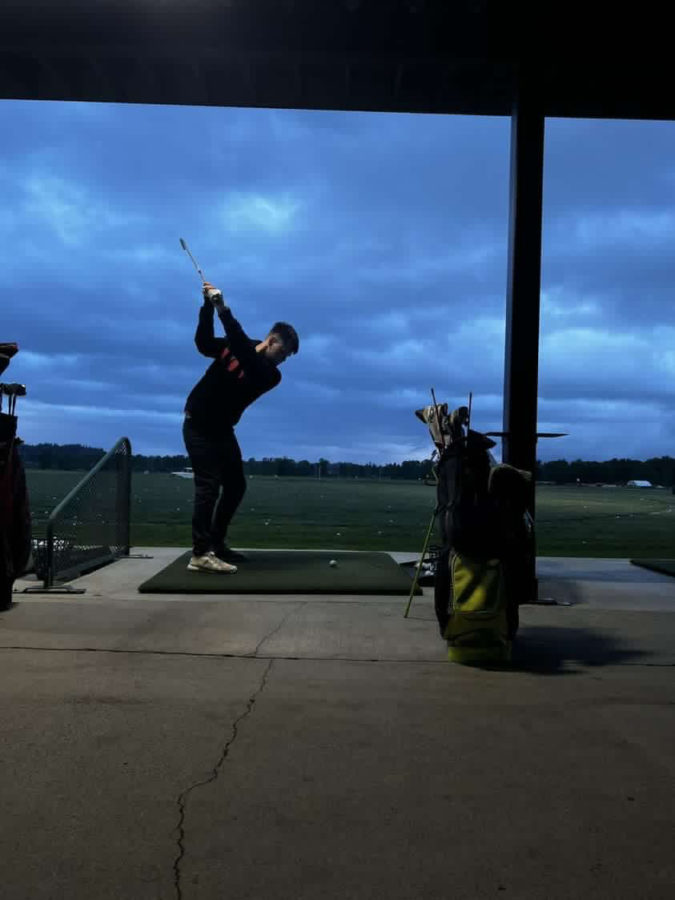 Breath, aim, swing: Senior Zach Hansen at snohomish driving range.
Zach perfects his swing at the driving range. 
