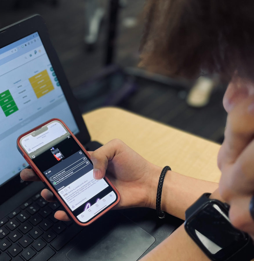 Senioritis: A student checks their phone for the latest update on a newly scheduled skip day. The now private Instagram page, @lakeseniors23only, responsible for organizing senior skip days, held its most recent poll on April 17.