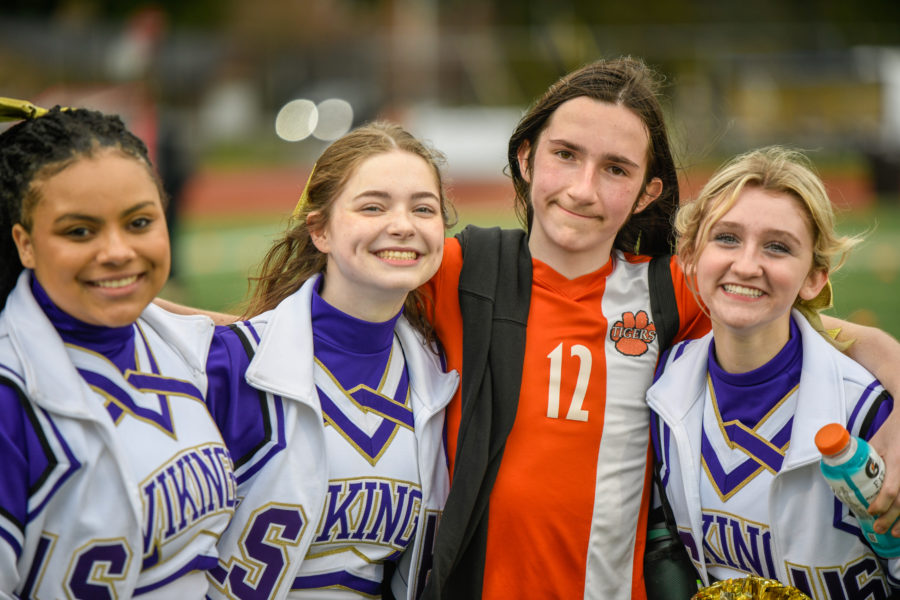 Say cheese: Lake Stevens cheerleaders, sophomore Maya Taylor, senior Alyvia Phenis, and junior Myla Pishue gather with Granite Falls Unified Soccer players after the game. This is only a tiny moment captured of all the school's students and staff gathered with each other to celebrate the event's success.