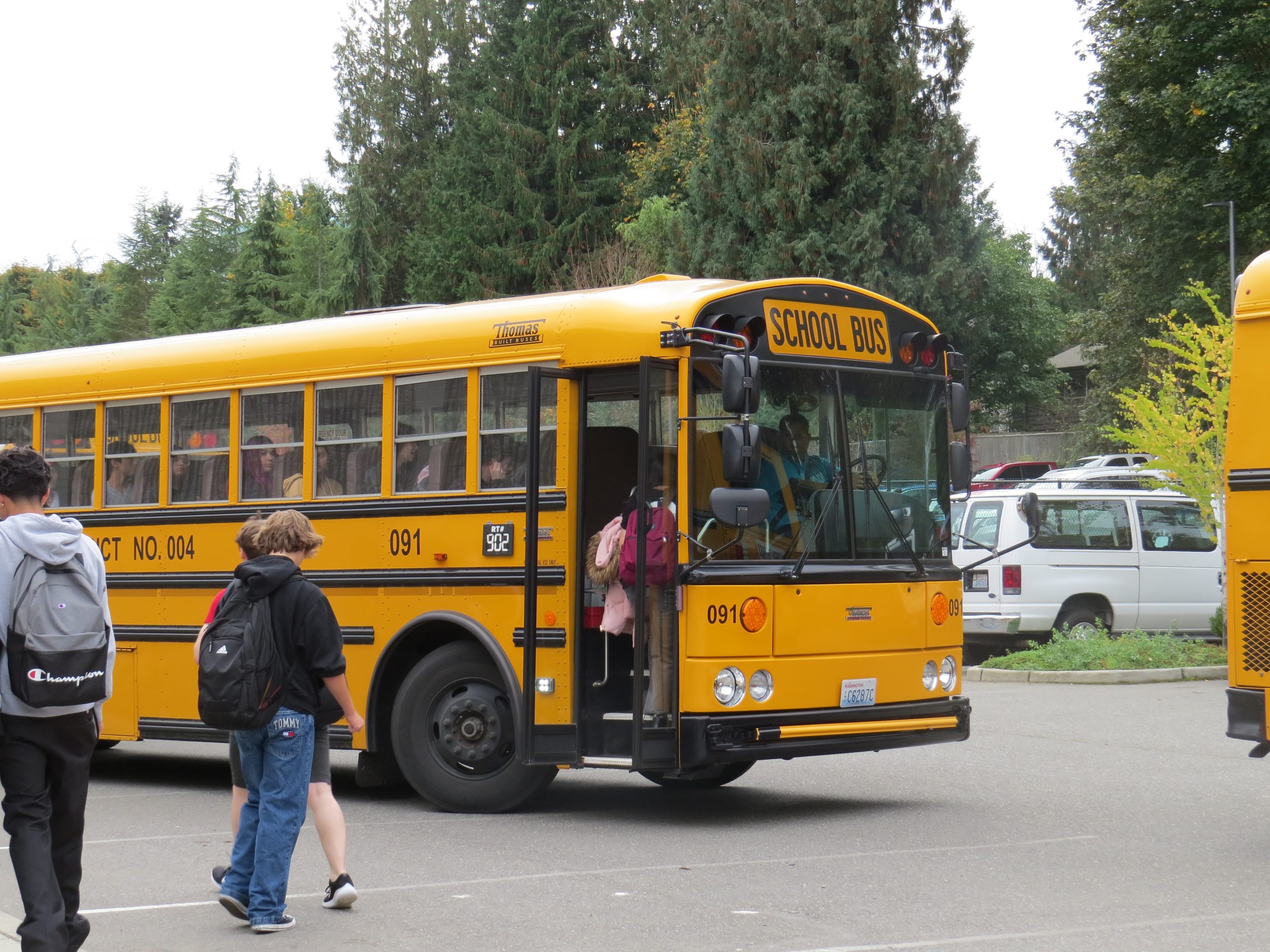 Students enter the bus after a full school day.
