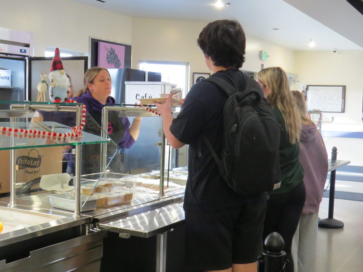 Multiple students wait to be served in the LSHS lunch line.