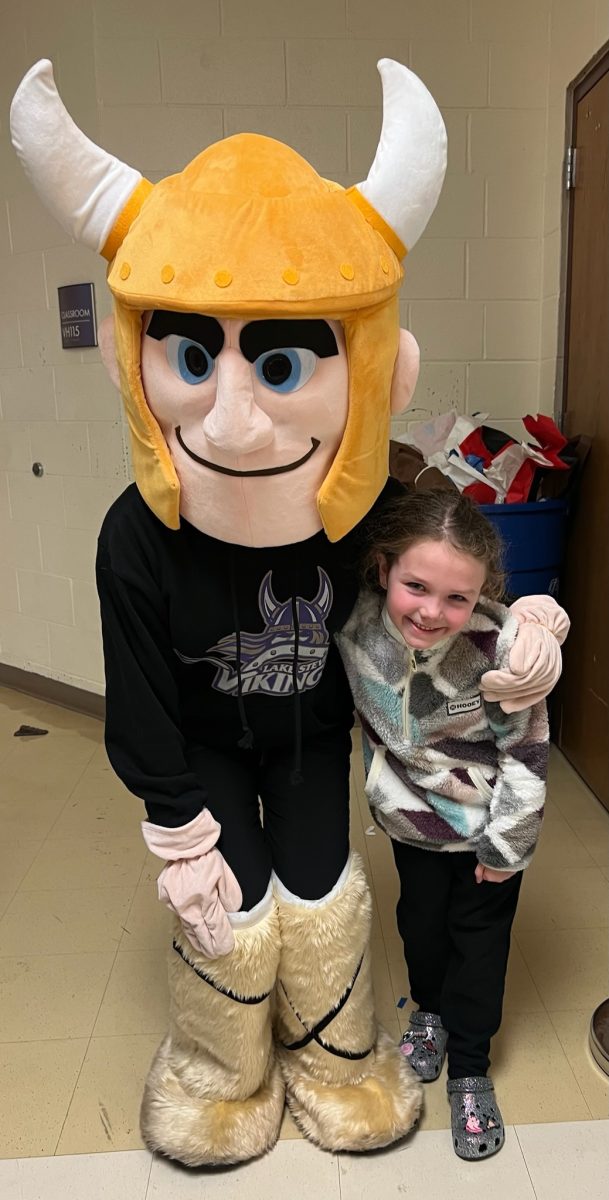 Tonya Grinde's niece and The Viking  pose together for a photo after the Viking  helped her get over her fear of the mascot.