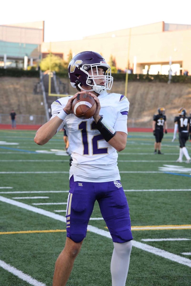 LSHS quarterback Kolton Matson warms up for the game against Bellevue High School on Sept. 8, 2023.