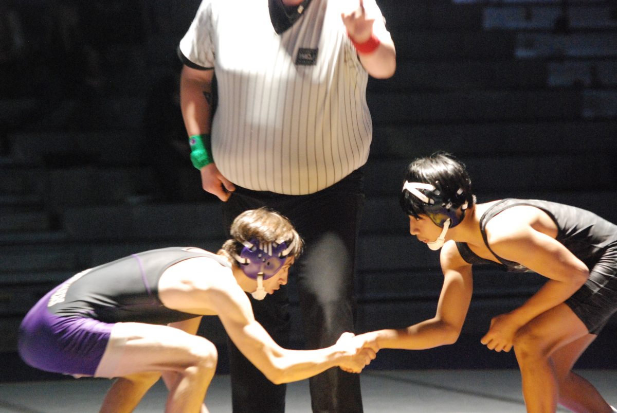 Senior Ahmad Banishamsa shakes his opponent's hand before his match against Jackson during the regular season. "I'm glad that I started wrestling. Everyone are like my brothers, so I fell in love with the sport," Banishamsa said.