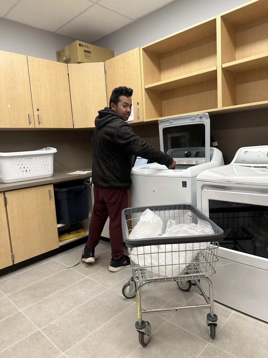 Structured learning center student Vibol Huy loads the washer and washes cafeteria laundry on a daily basis.