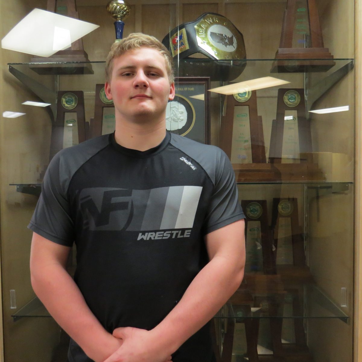 State Champ Wrestler! Senior Koen Mattern stands in front of the new Lake Stevens wrestling trophy case. Mattern won the belt on the top shelf at the 2023 Brian Keck Memorial Preseason Nationals tournament.