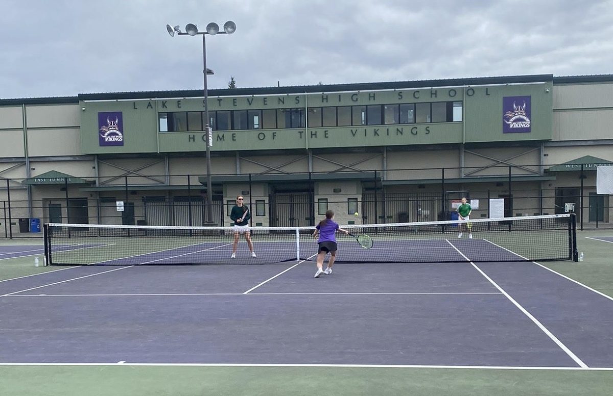 Lady Vikings take to the courts to face the Everett Eagles in a tennis match. Senior Izabella Daer charges to the net to make a point-saving play. “Great team win everybody,” Pitkin, the Varsity coach said after the 6-1 win overall.