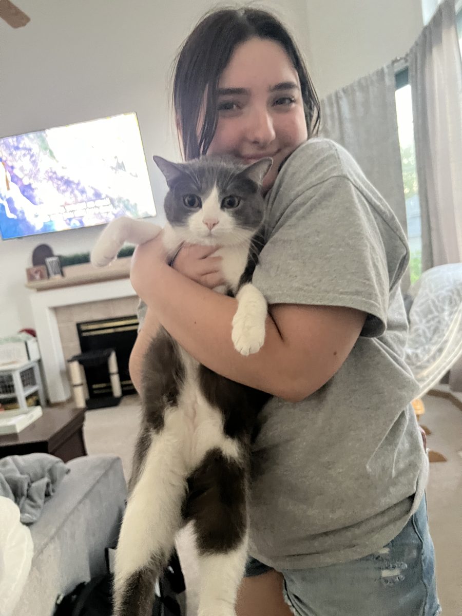 Junior Abigayle Cozad embraces her cat, Luna, who brings her a source of happiness in her life.