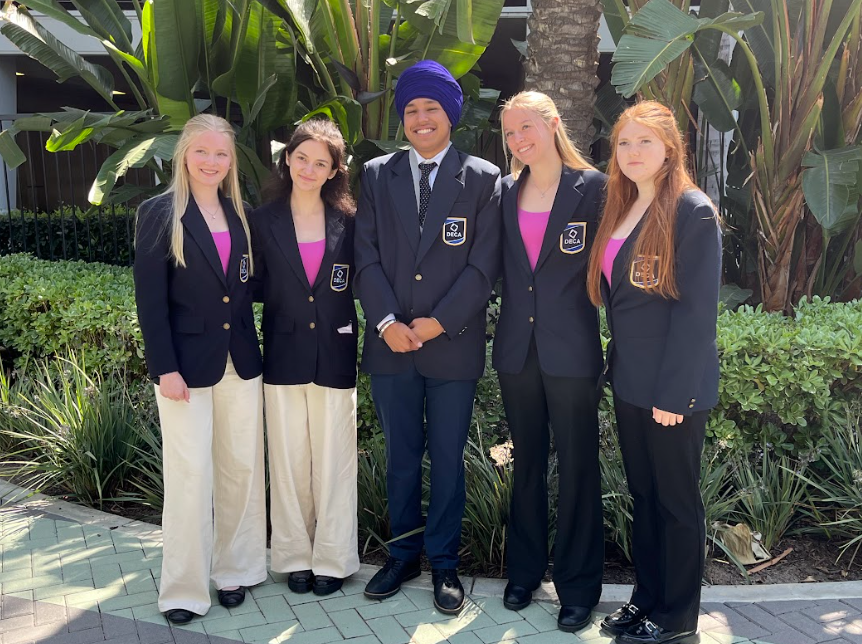 Student competitors Ava McGee, Lilly Turner, Sahib Malhi, Kylie Monson and Payton Thompson Vanausdeln, gathered together after Malhi was awarded his medal for being a top test taker.