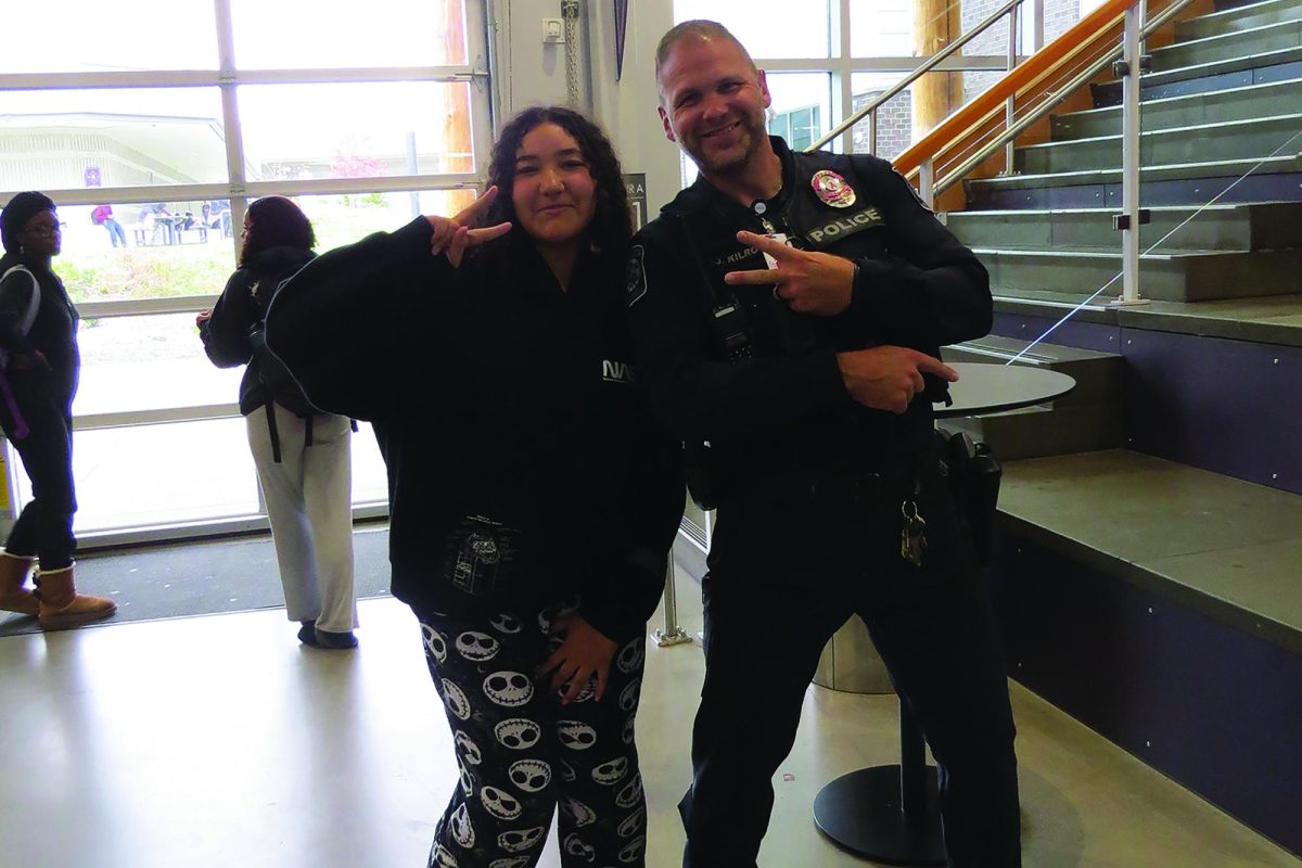 Sophomore Mikayl Grunder and Officer Kilroy pose together on Pajama Day.