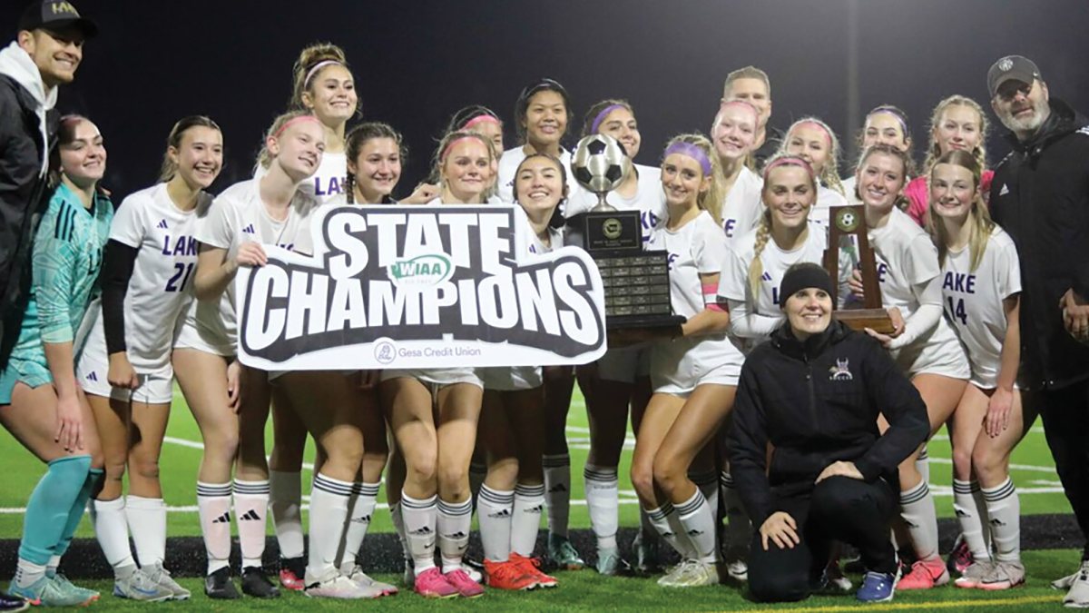 The girls' soccer team celebrate their victory against Woodinville as the first girls' sports team in school history to win state.