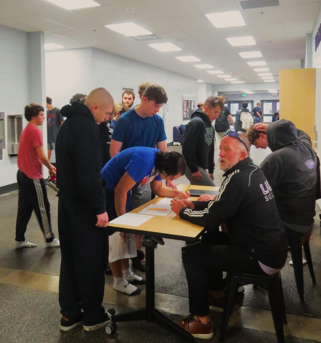 Lake Stevens boys wrestling sign in for practice during the first week of wrestling season.