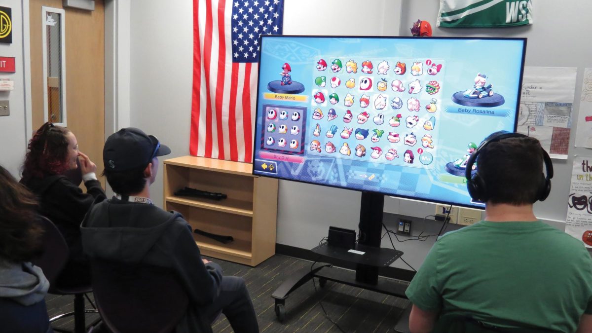 Esports players take some time to enjoy playing Mario Kart with their friends.