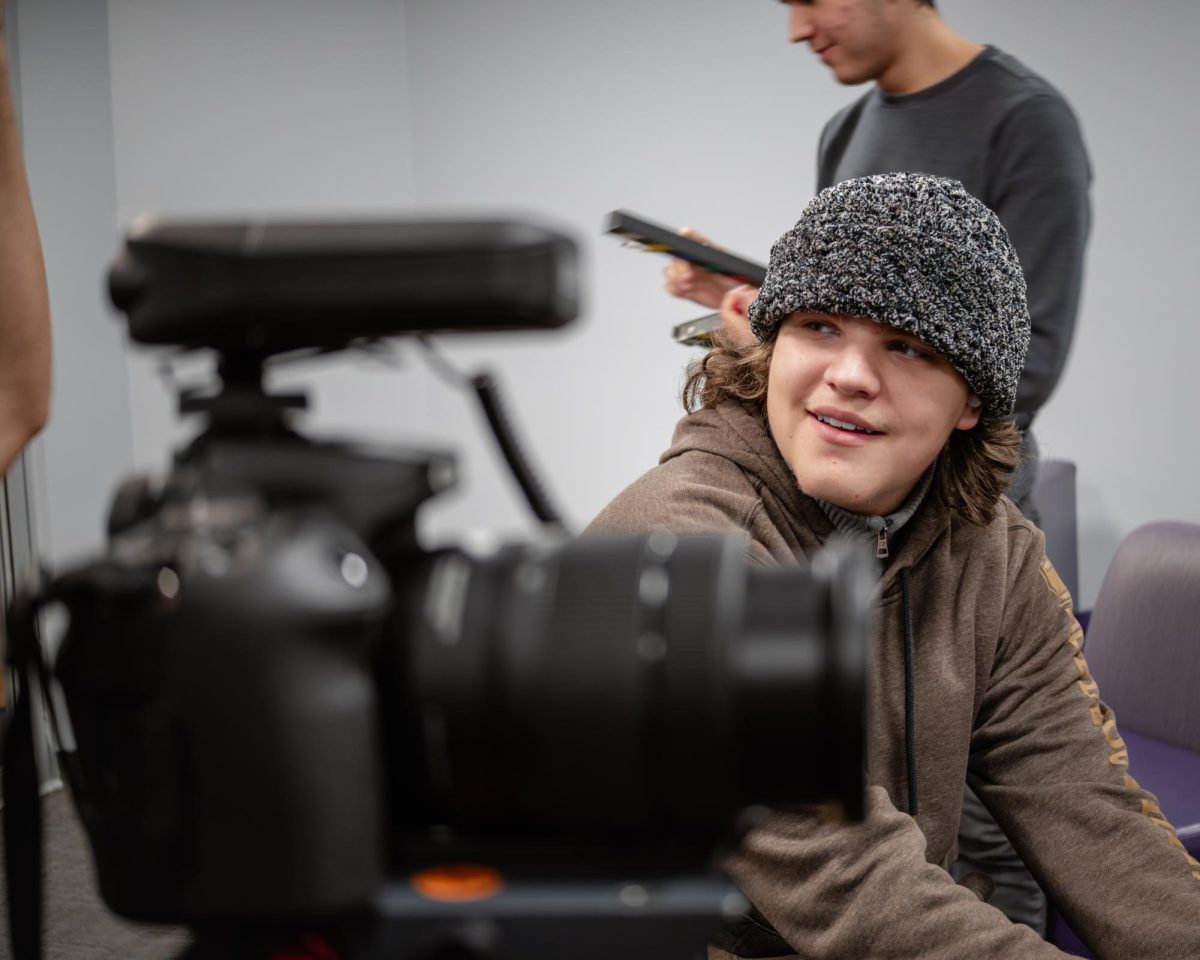 Senior Vladimir Schiffelbein readies a DSLR camera, to ensure sharp focus of the interviewee.