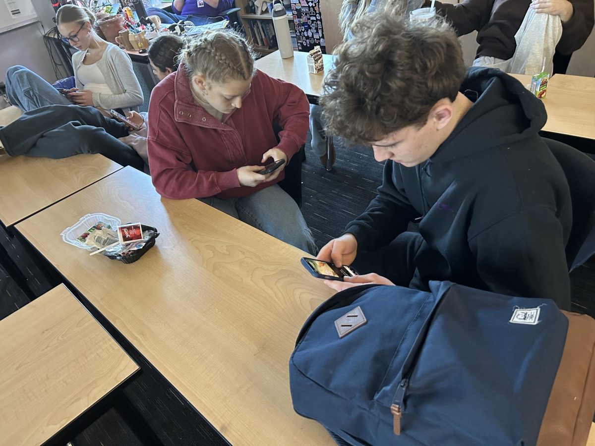 Oliver Paisley and Baylee Smith, Juniors at Lake Stevens High School, find themselves distracted in the classroom on their phones.