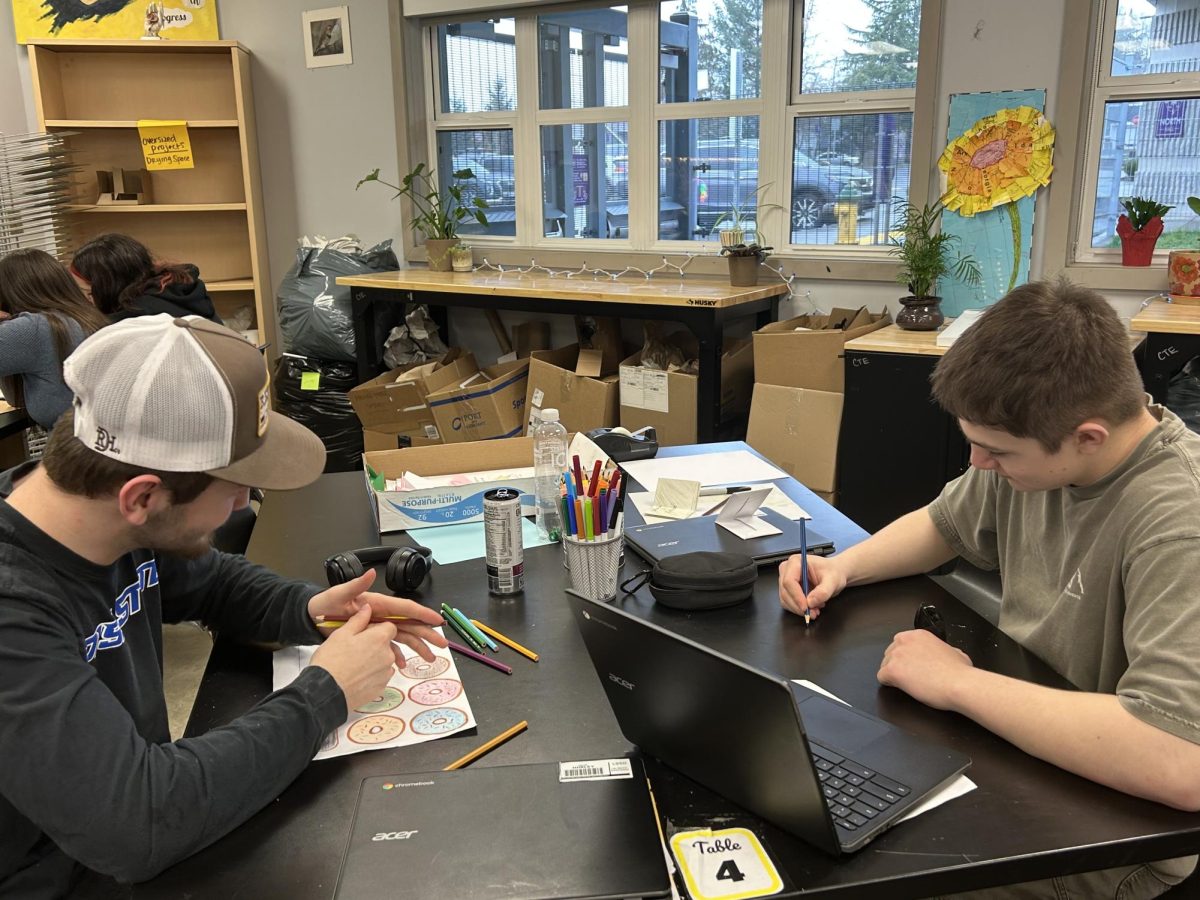 Seniors Jake Hurley and Thad Bradley work hard in art class as they finish up their work.