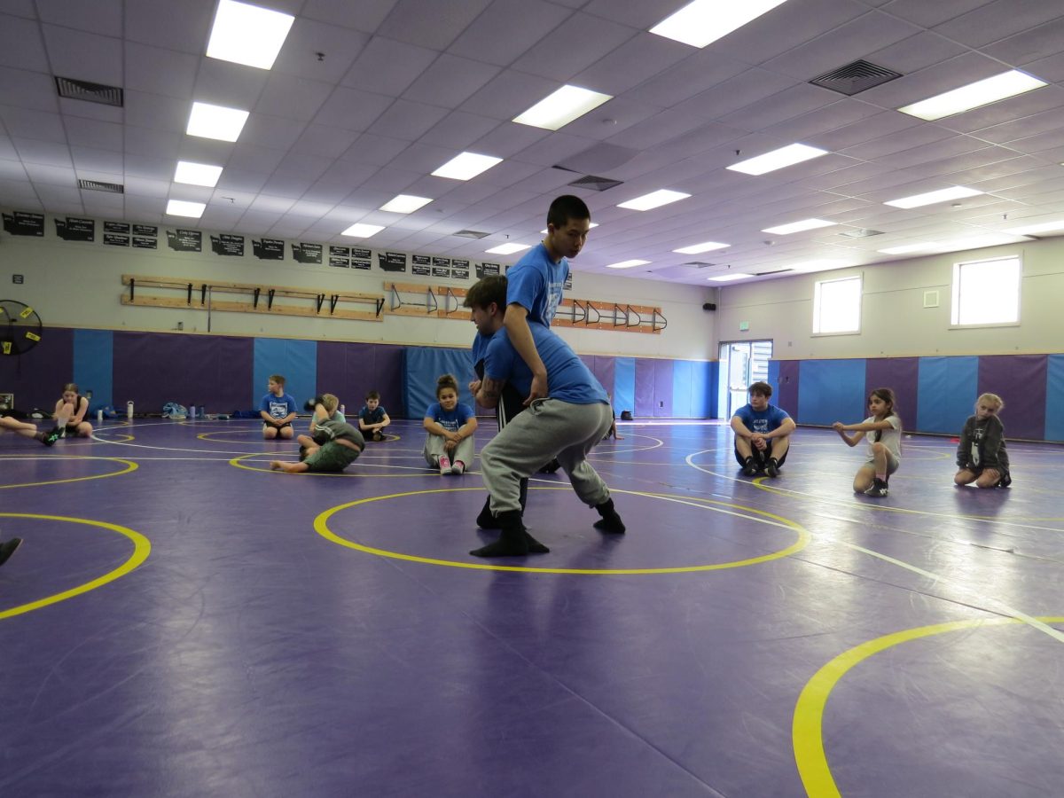 Senior Sam Irizary and sophomore Issac Chu show a move during Slammers practice.