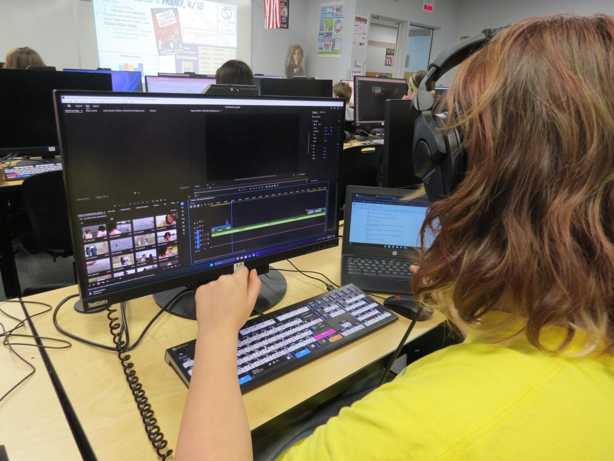 Senior Luke Gicquel works on putting together the shots for his group's music video.