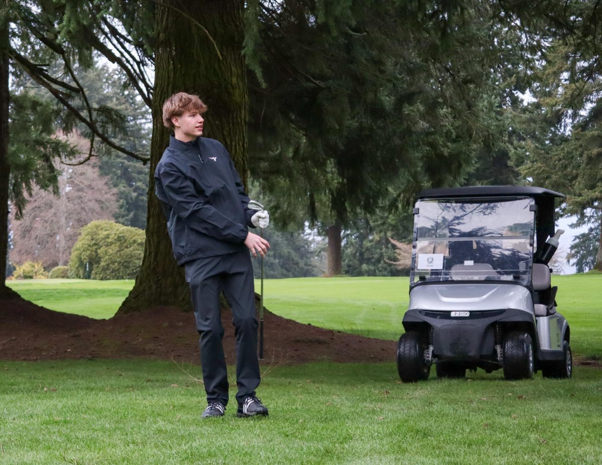 Senior Jackson Sanders-Pugh practices in the rain, preparing for
his final competitive season as a varsity golfer.
